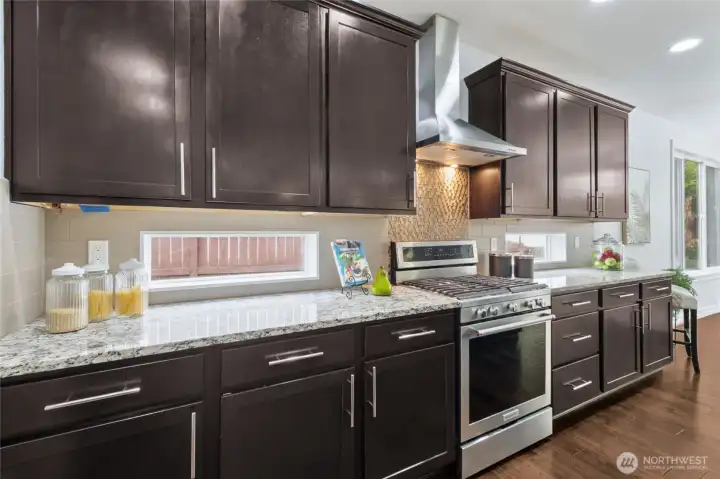 KitchenAid stainless steel appliances, including a beautiful gas stove, elevate this well-appointed kitchen.
