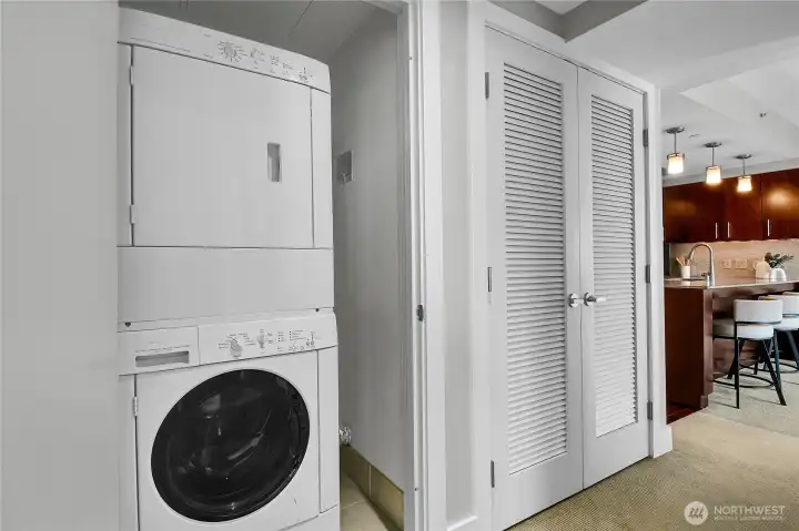 The laundry closet has a stack Bosch washer and dryer.