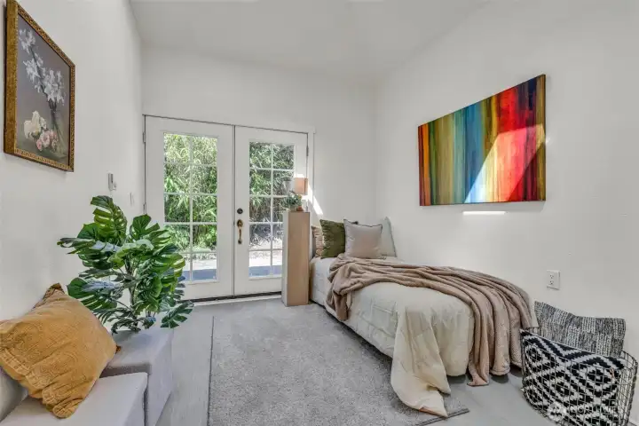 Upstairs bedroom with backyard patio access.