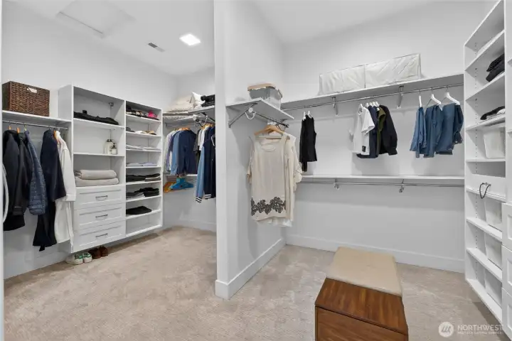 Large double primary closet with builtins