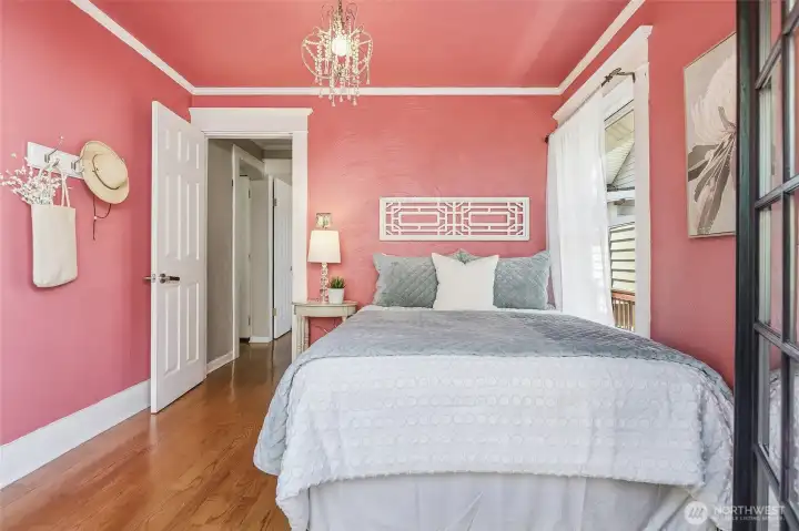 Bedroom 1 on main level was used as an office with french doors leading to backyard.  Staged as bedroom to show it can be used either way!  Lots of light, crown molding, intricate trimwork, and a chandelier!