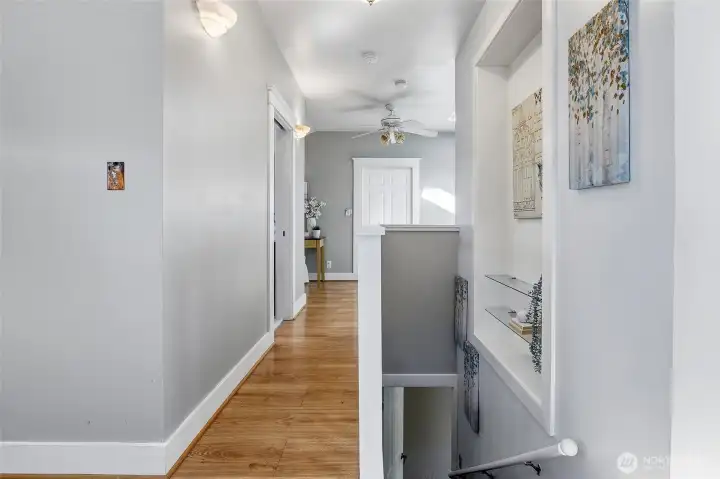 Stairway from main level to upper level plus art niche, sconces and ceiling fan!