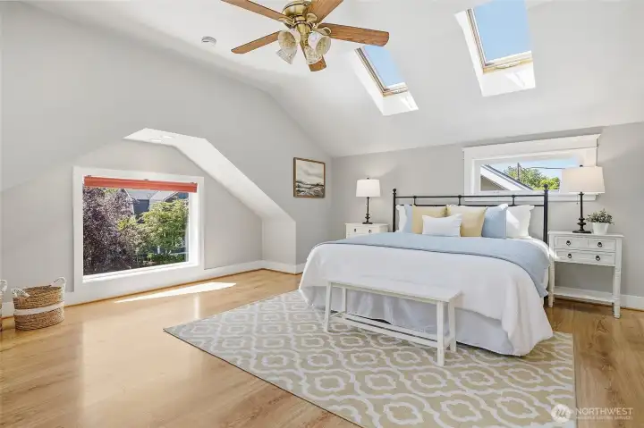 Both bedrooms upstairs could be primary bedroom.  This room was used as a tv room, sewing/hobby area, and exercise area.  Again, bright and airy with big windows and skylights with ceiling fan!