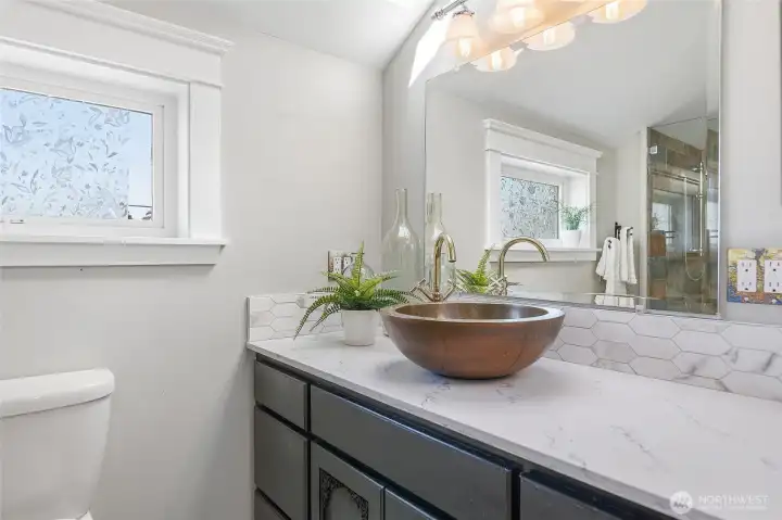 Beautifully remodeled primary bathroom on upper level.
