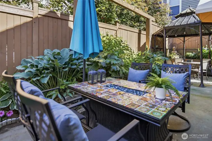 Private backyard with fire table is perfect for entertaining or enjoying your favorite beverage!  Day or night!