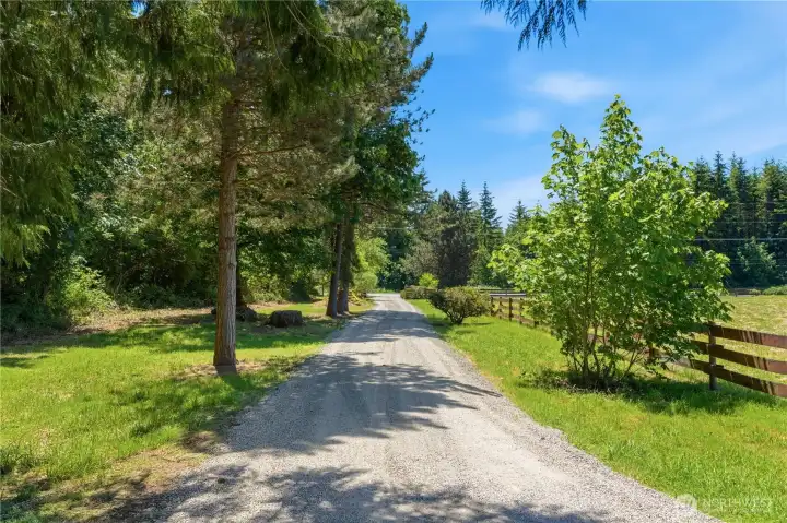 Two separate gravel driveways into the property offer convenience of access. Enjoy the perimeter of mature trees! Two separate gravel driveways into the property offer convenience of access. Enjoy the perimeter of mature trees!