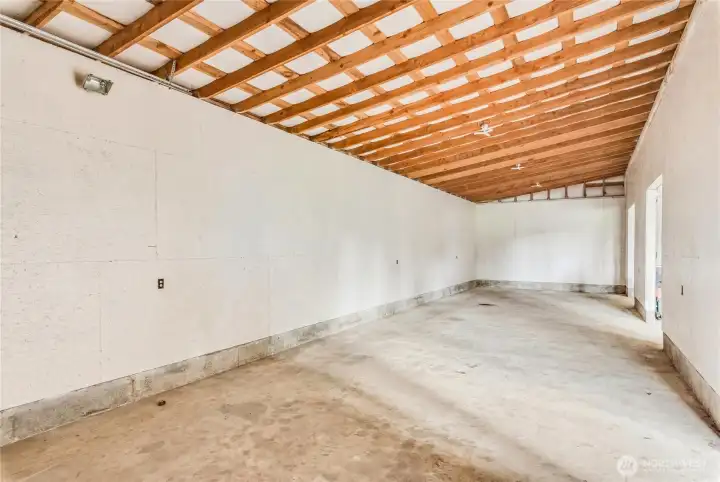 A fourth exterior vehicle door measures 12 ft high, accessing this separate side room. A fourth exterior vehicle door measures 12 ft high, accessing this separate side room.
