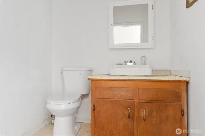 A convenient half bath is located in the shop. A convenient half bath is located in the shop.