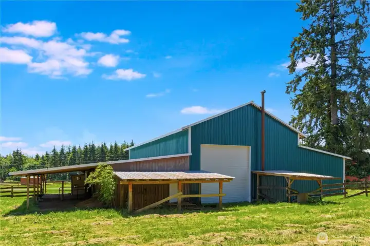 The back side of the shop features covered storage space. Also notice the large carport on the side. The back side of the shop features covered storage space. Also notice the large carport on the side.