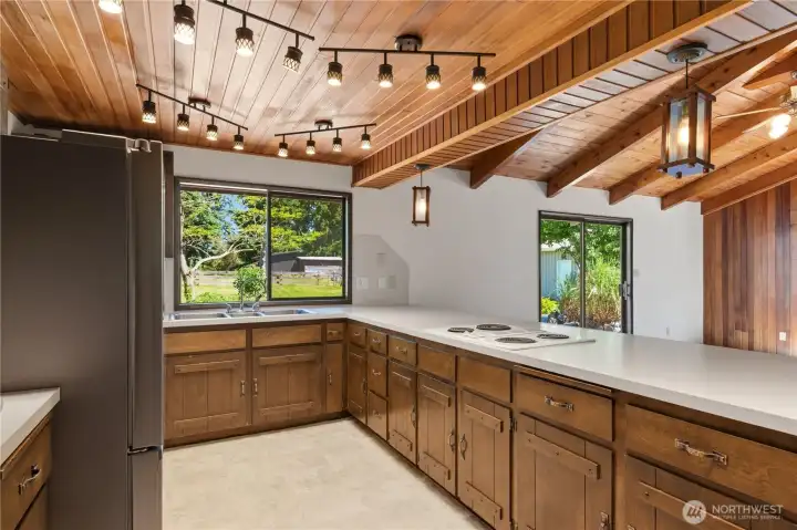 The wood theme carries into the open-style kitchen, with a large countertop for whipping up favorite meals. The wood theme carries into the open-style kitchen, with a large countertop for whipping up favorite meals.