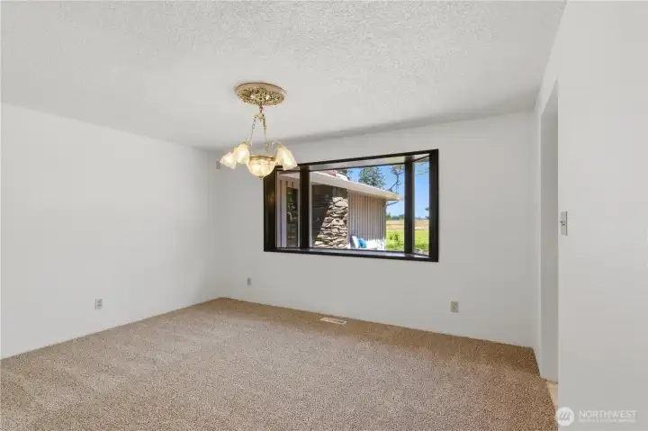 Adjacent to the kitchen is the formal dining room, overlooking the back deck and the greenery of the property. Adjacent to the kitchen is the formal dining room, overlooking the back deck and the greenery of the property.