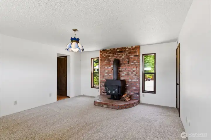 The primary suite is located in the quiet back corner of the home. It has its own wood stove, as well as a private bath and multiple closets. The primary suite is located in the quiet back corner of the home. It has its own wood stove, as well as a private bath and multiple closets.