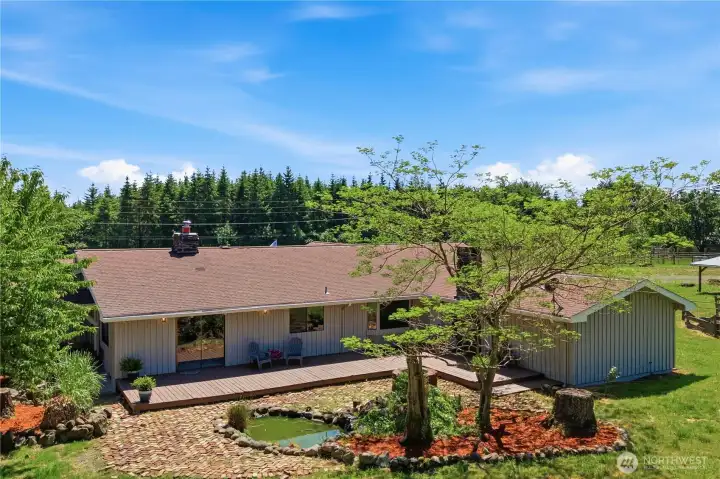 Behind the home is a large deck, perfect for enjoying the serene views of the property and the mature trees. Behind the home is a large deck, perfect for enjoying the serene views of the property and the mature trees.