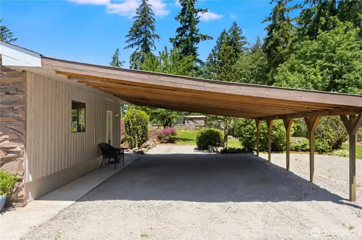 Shown here is the oversized carport on the side of the home, offering covered storage for boats, 4-wheelers, hobby cars, etc. Shown here is the oversized carport on the side of the home, offering covered storage for boats, 4-wheelers, hobby cars, etc.