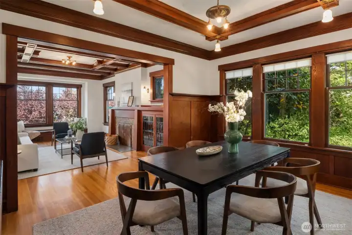 The oversized dining room features a private view of the gardens as well as box beams, wood wainscoting and built-in cabinetry with leaded glass.