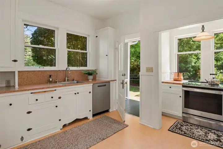 The Marmoleum floors keep the period feel intact. The door leads to the back covered porch and back yard.