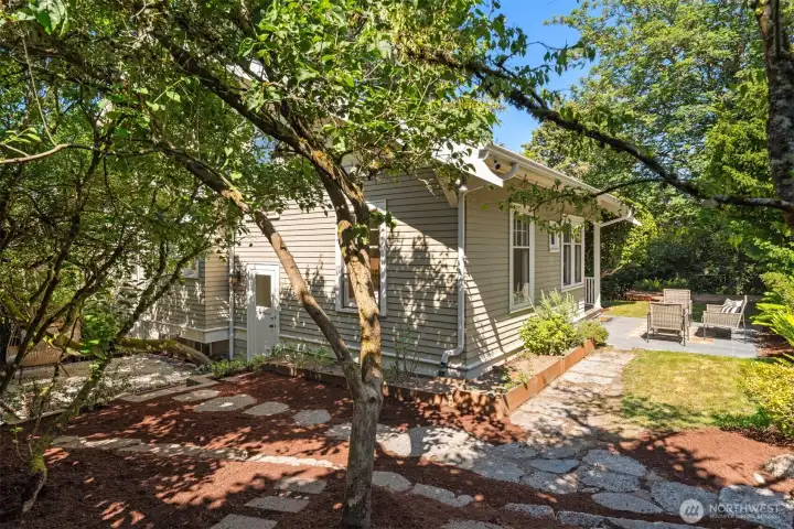 This is the west side of the house with a third entrance door which leads down to the basement as well as to the main floor. Easy access from three sides!