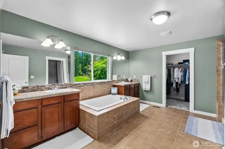 Morning and evening you'll love the privacy and views offered in this large en suite bath with walk-in-closet!