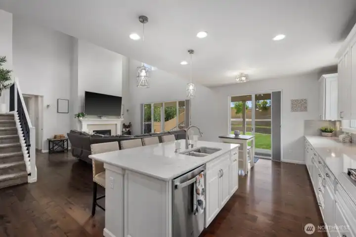 The connection between the kitchen, great room, and outdoor living spaces makes the entire main level feel effortless.