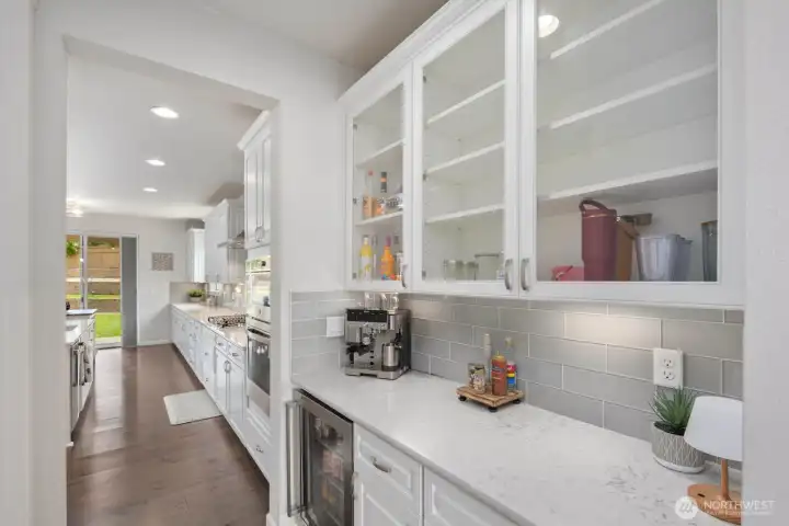 The kind of space you don't realize you want until you have it. A dedicated coffee bar and butler's pantry help keep the kitchen beautiful while still handling real life.