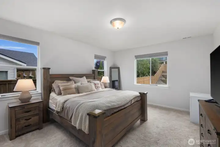 The primary suite offers a spacious retreat with plenty of room to relax, recharge, and enjoy a little separation from the rest of the home.