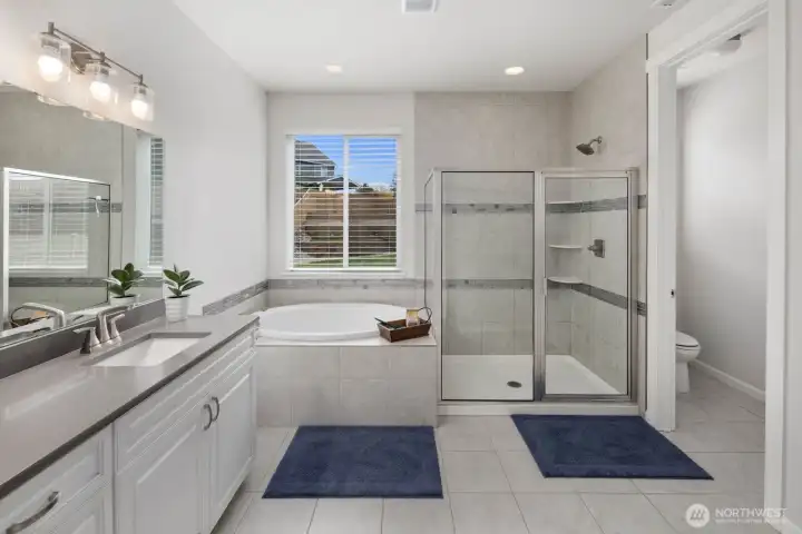 Bright, spacious, and thoughtfully designed, the primary bathroom creates a spa-like setting for everyday routines.