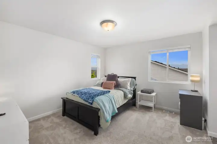 Bright and inviting, this bedroom offers a comfortable retreat with soft natural light, neutral finishes, and plenty of space to make it your own.