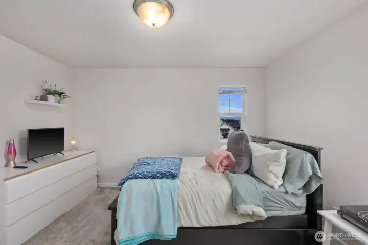 Large windows and a clean, modern palette give this bedroom an airy feel that's ready for any style or use.