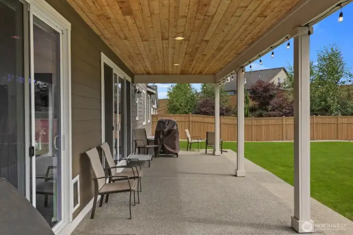 The covered patio extends your living space outdoors, providing a comfortable spot for dining, entertaining, or enjoying the backyard in any season.