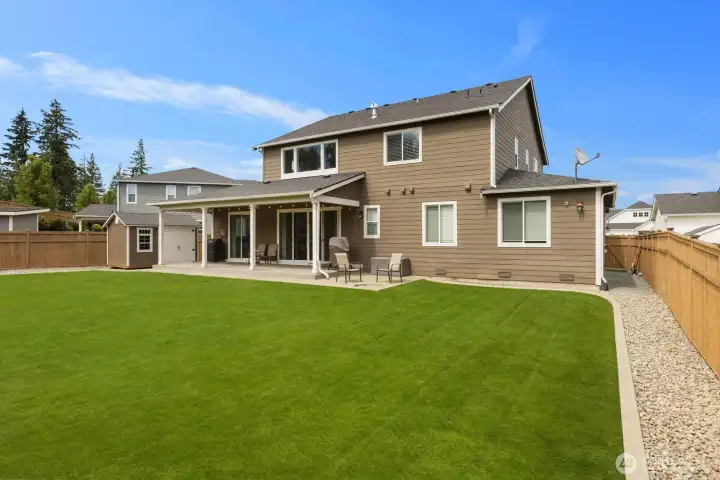 With a covered outdoor living area, spacious lawn, and thoughtfully designed landscaping, this backyard was built to be enjoyed.