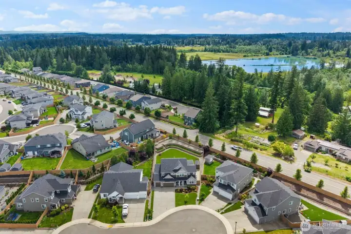 This aerial perspective highlights the property's generous lot size, thoughtfully designed outdoor spaces, and position within a well-established neighborhood.