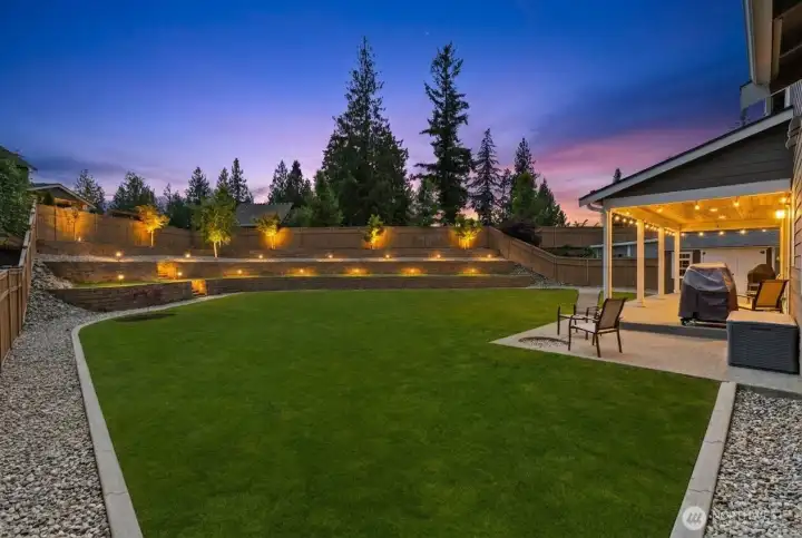The outdoor spaces were designed with the same attention to detail as the interior, from the landscape lighting and retaining walls to the expansive lawn, covered patio, and fully fenced backyard.