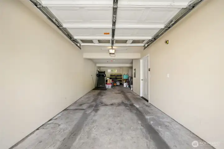 Two car tanden garage with extra storage space back on the right and door to fenced out door area. Two car tanden garage with extra storage space back on the right and door to fenced out door area.