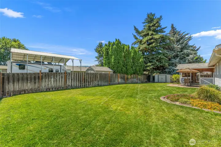 Large back yard and covered patio with another patio that is uncovered. Large back yard and covered patio with another patio that is uncovered.