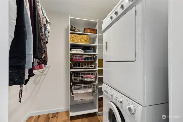 Primary suite closet with built ins and laundry!