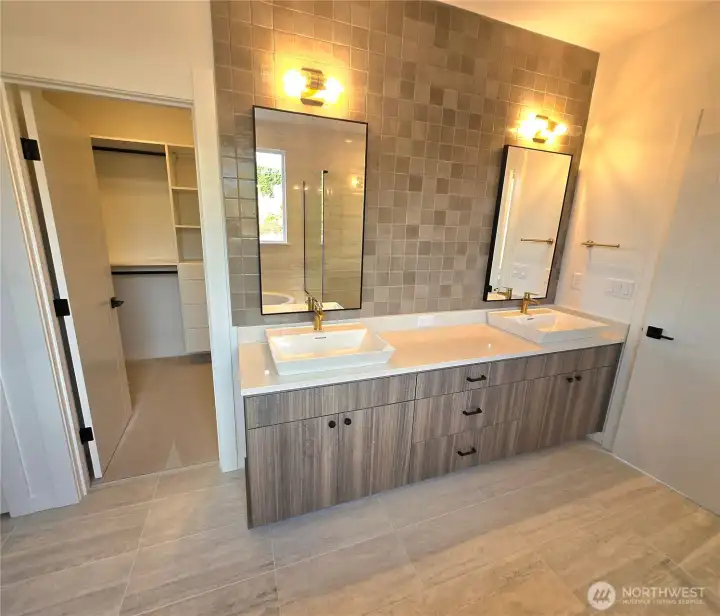 Primary bath features solid surface quartz vanity accented by full wall height 4x4 Marazzi tile & Vox  Kohler sinks
