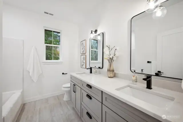 Upstairs main bathroom with tub and shower.