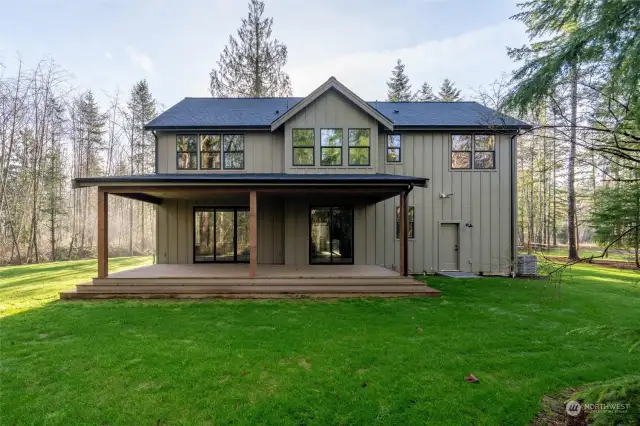 A massive covered deck off the back of the house, perfect for listening to the birds in the trees all year long.