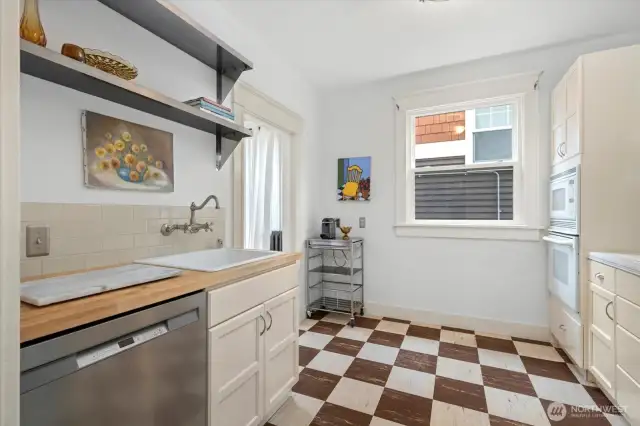 Oversized sink, updated cabinetry, subway tile backsplash and large window