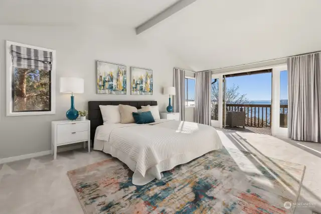 Gorgeous primary bedroom with cathedral ceilings and private deck with amazing views