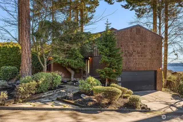 This sunny, elegant home sits on a large corner lot, where breathtaking views of Lake Washington, Mt. Rainier, and the Seattle and Bellevue skylines take center stage