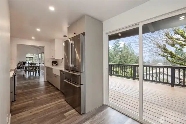 Main Level Kitchen with Slider to deck. All new plumbing & light fixtures throughout home!