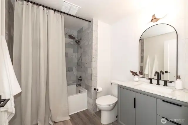 Main Level Full Bath recently updated with extensive Carrara marble & Zellige tile. New vanity with Carrara marble countertop, undermount sink & new fixtures!