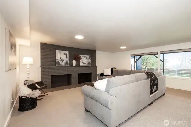 Lower Level Living Room- Fireplace recently painted with new custom sandstone hearth.