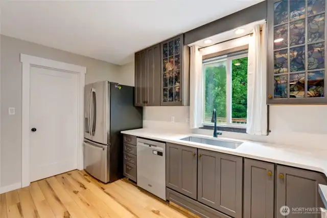 The heart of the home is the updated kitchen, thoughtfully designed with quartz countertops, sleek cabinetry, and ample workspace—perfect for both daily living and entertaining.