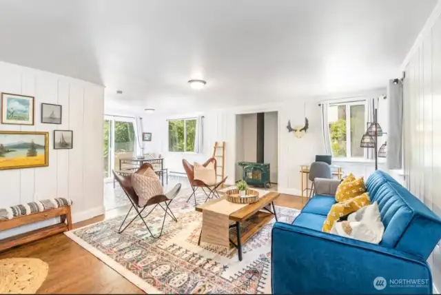 Cabin (Airbnb) Living room is light and bright with hardwood floors and a pellet stove