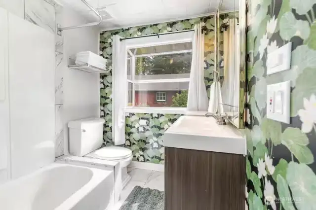Cabin bathroom, with full bathtub, is light and bright.