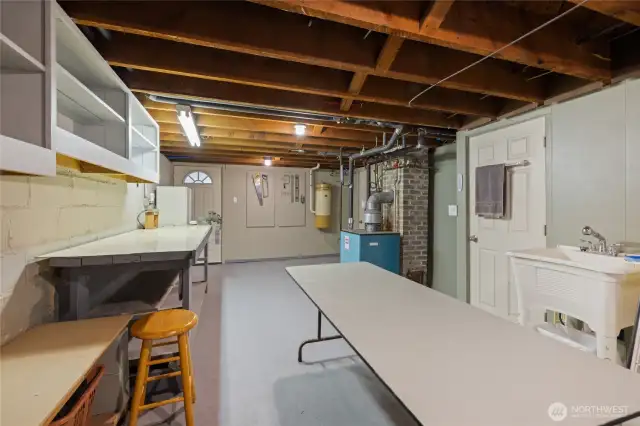 Workroom in basement with tons of storage, the long table stays to work on projects!