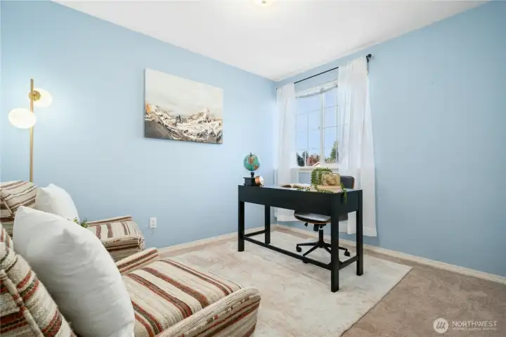 Bright and airy additional bedroom with flexible options as a home office, guest room, or crafts room.