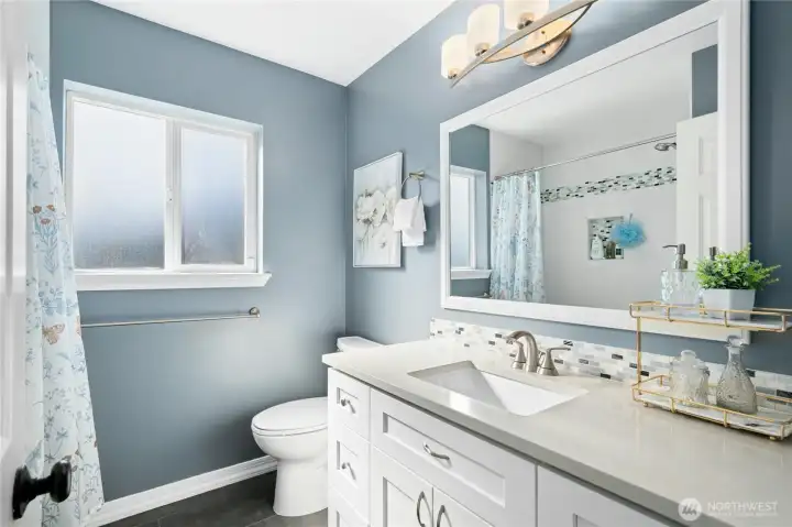 Full bath with tub/shower combo.